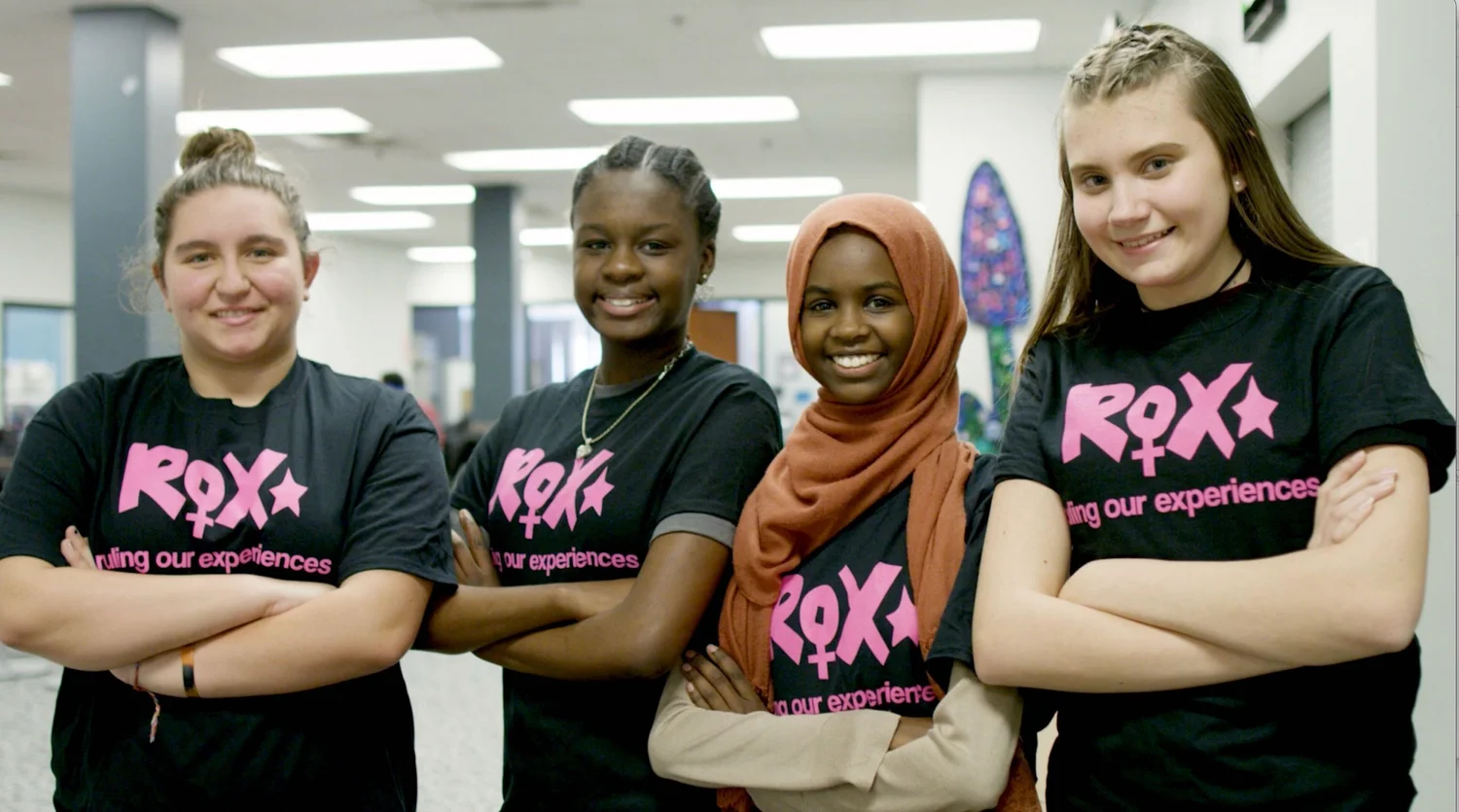 Smiling ROX program participants with arms crossed